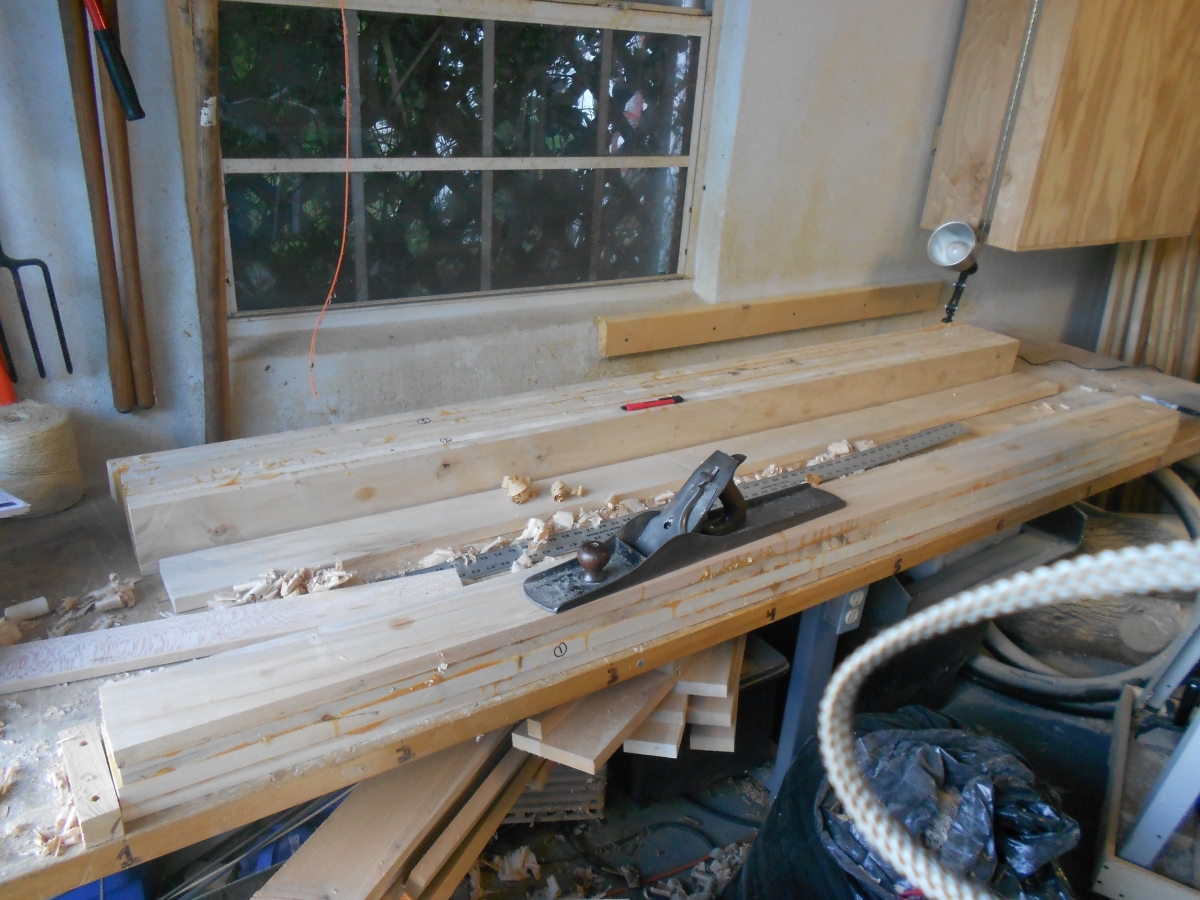 Began by gluing up four slats to make sections of the benchtop, Then planed them flat for further gluing.