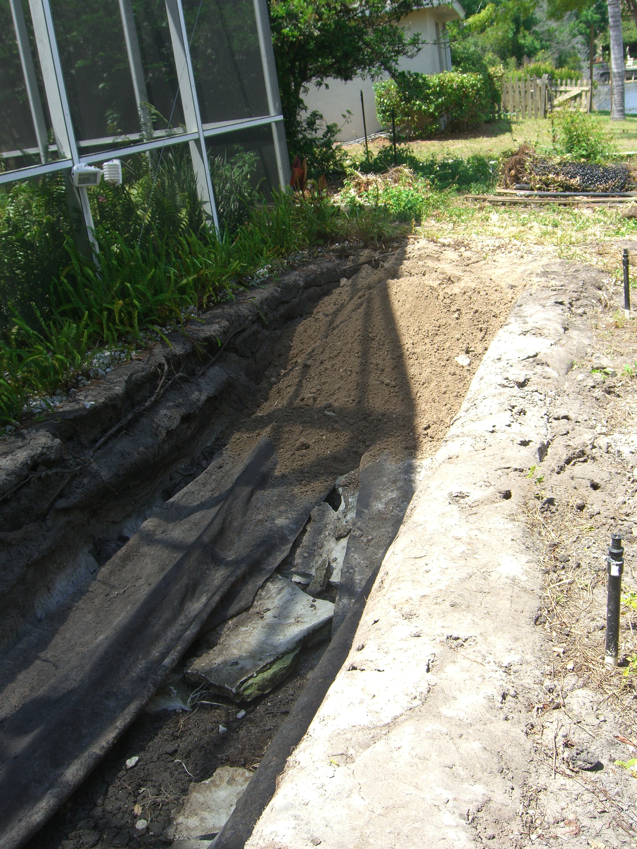I began filling this 40' long koi pond in March 2009. Knocked in the rock and cement edging and then wheelbarrows of fill 