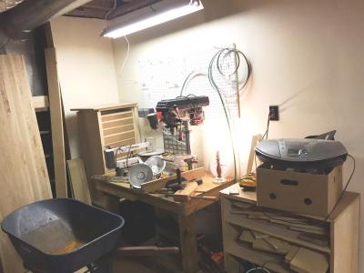 Previous owner's little shop area, with my long-suffering workbench and cabinet project sitting in morose impatience. Soon, fellas, soon.