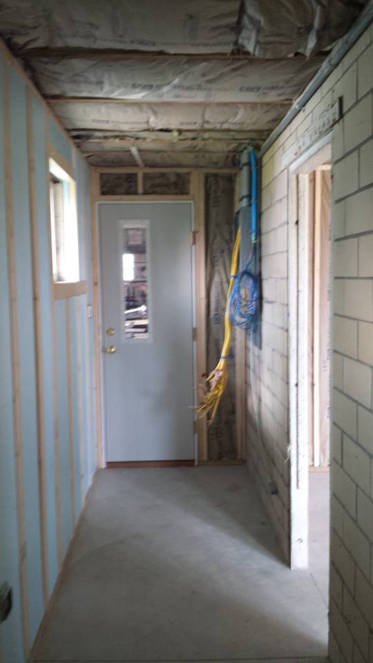 Hall behind the wall where the cabinet will be installed, during remodel