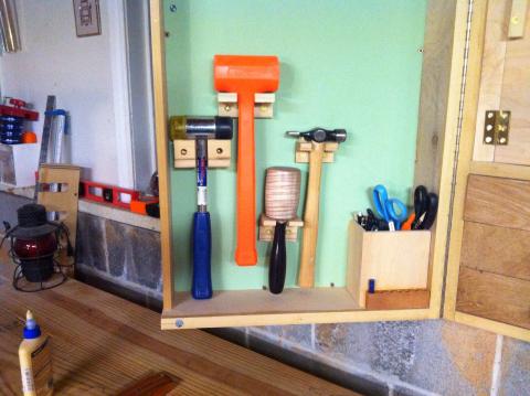 Hammers and mallet mounted in left door of the wall tool cabinet